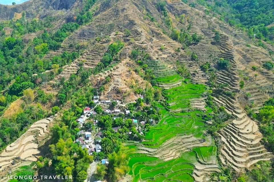 Simple homes of Barangay Capnayan tucked into green rice paddies on Mt. Igmatongtong’s slopes