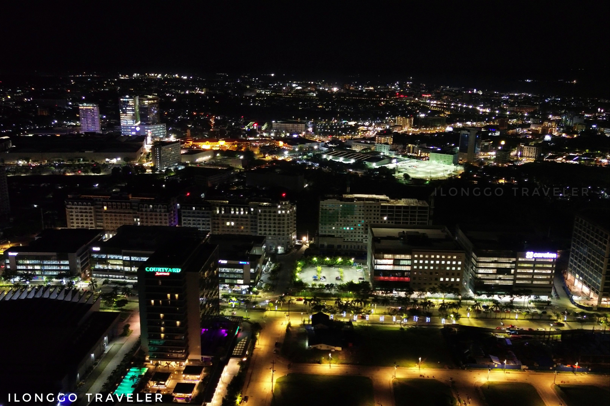 Night skyline of Iloilo City Business District with illuminated high-rise buildings and city lights