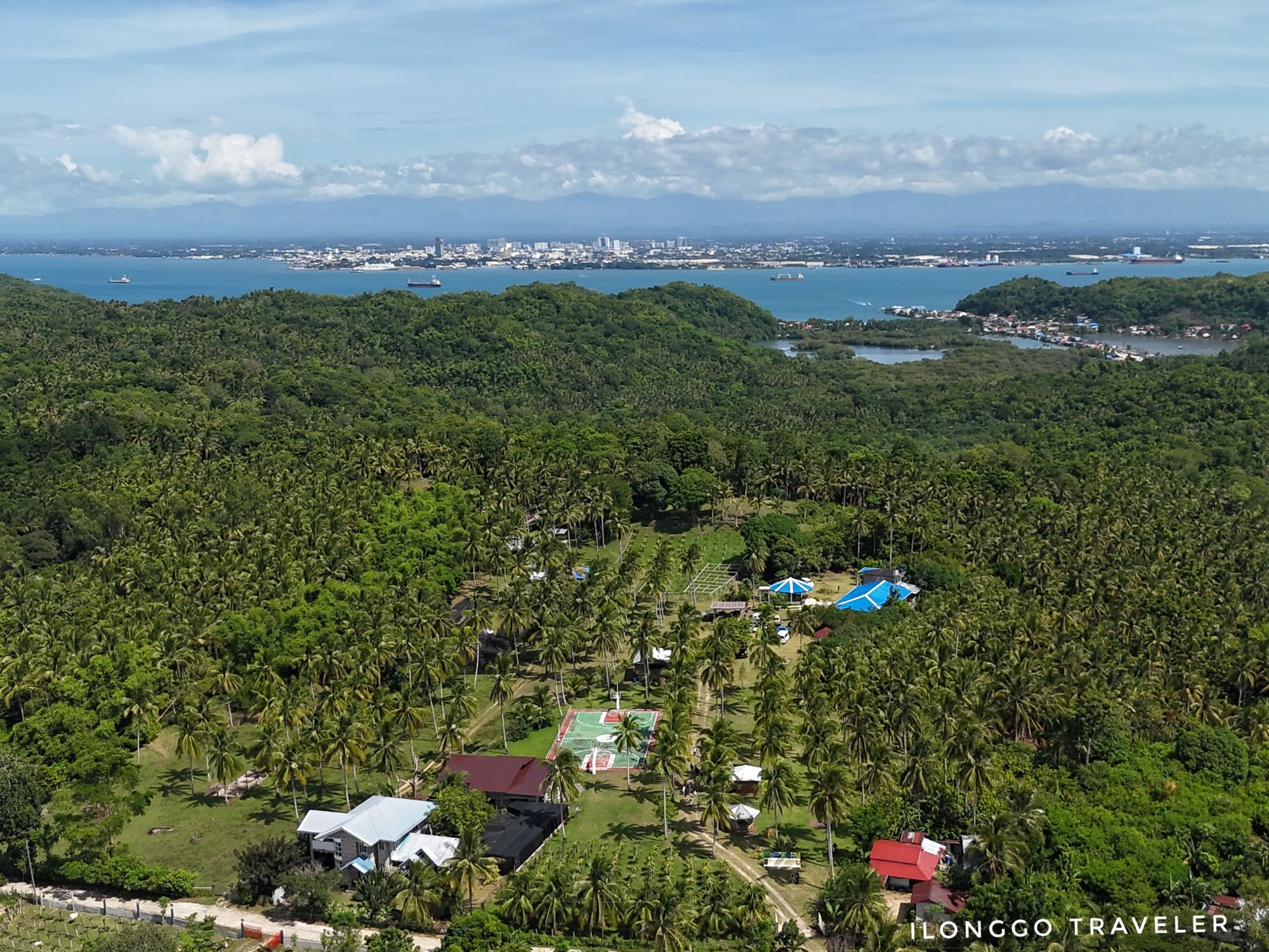 Aerial view of Mae’s Farm in Guimaras with Iloilo City skyline in the background