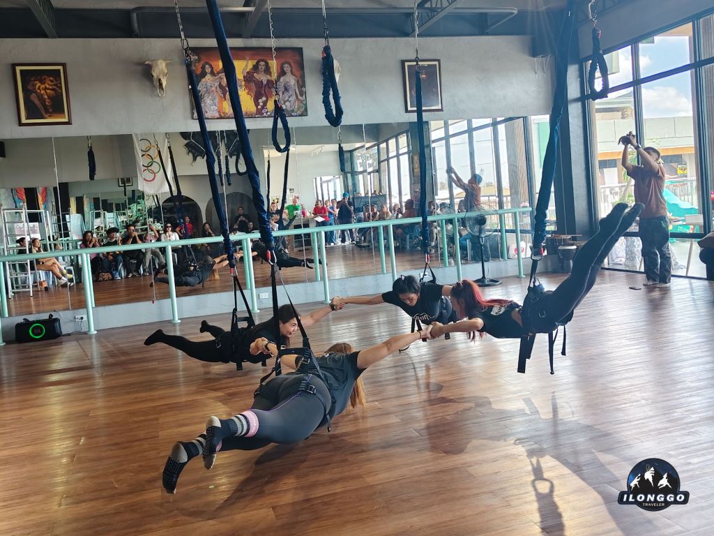 Woman performing bungee fitness workout suspended in harness during Bungee Physio class at Bereber Pilates Iloilo